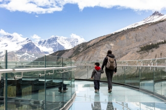 A woman and son walking on a mountain viewing platform in Canada