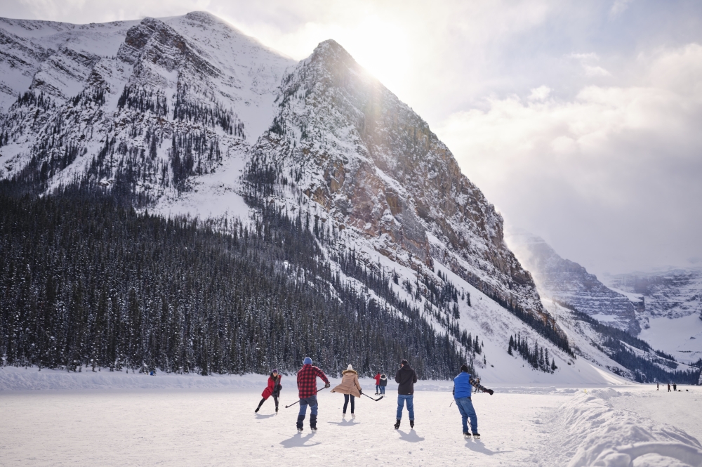 Group of people playing hockey on the frozen lake in Banff